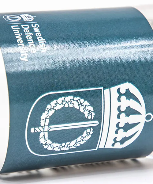 Försvarshögskolans logotyp på blankt blått papper